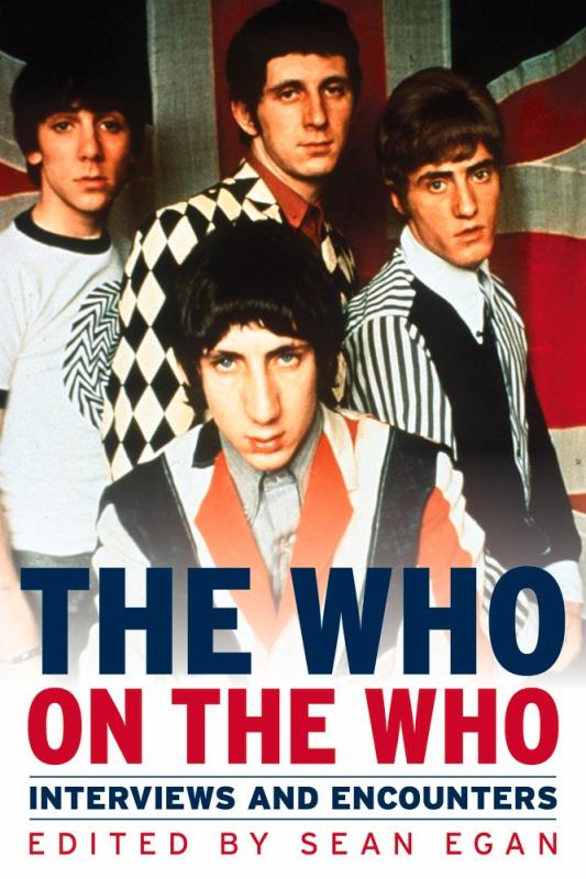 an old picture of the band The Who, in front of a british flag